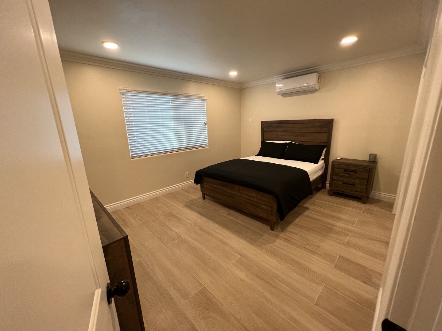 Private bedroom with natural light, bed and workspace at Her Aria recovery housing for women, Montclair CA