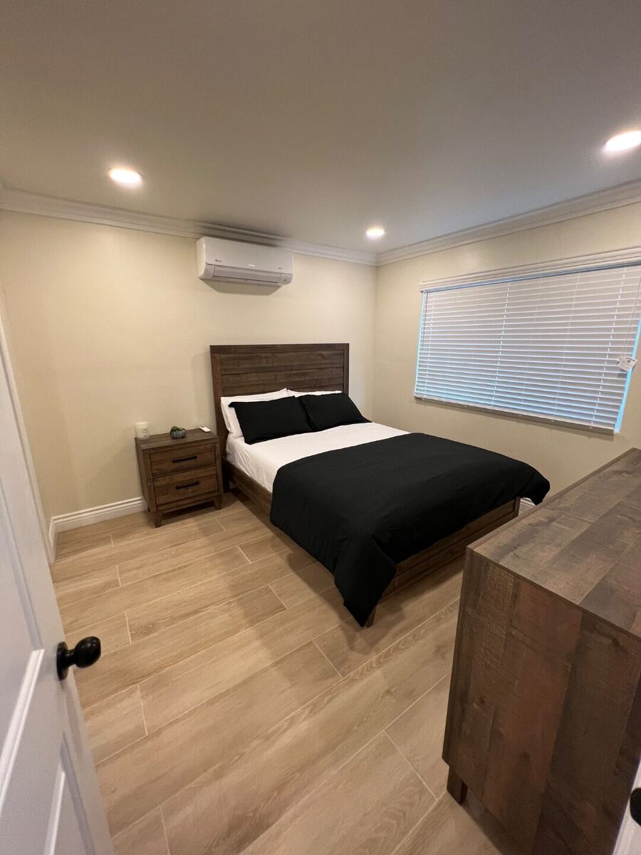 Semi-private bedroom in a women's recovery residence in Montclair, CA — two beds per room