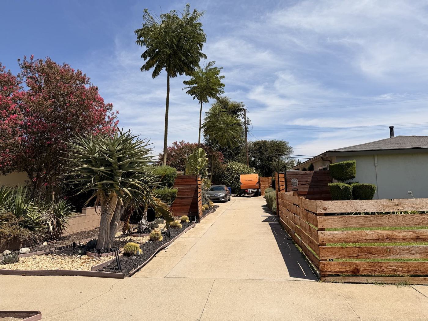 Private gated driveway lined with palms at Her Aria women's recovery residence in Montclair, California