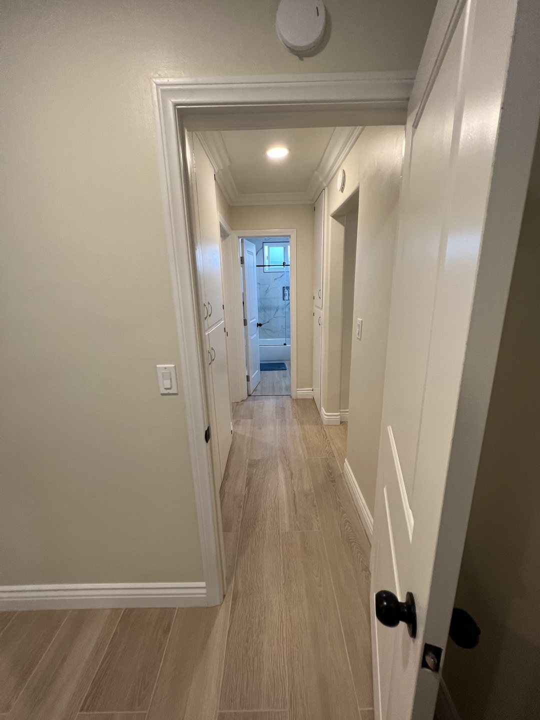 Interior hallway connecting bedrooms and common areas at Her Aria women's recovery residence in Montclair
