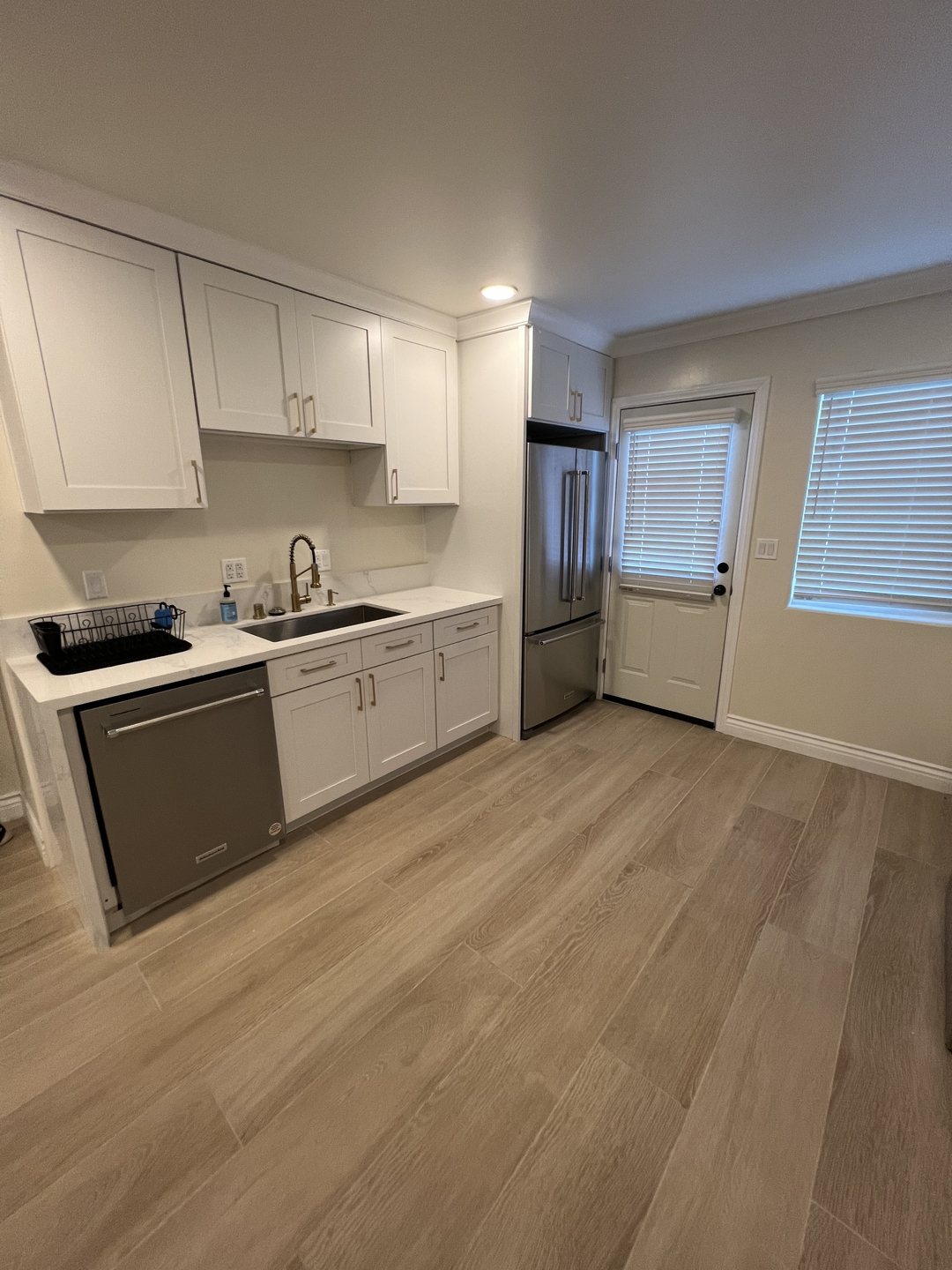 Kitchen counter, sink and refrigerator available to all residents at Her Aria in Montclair, California