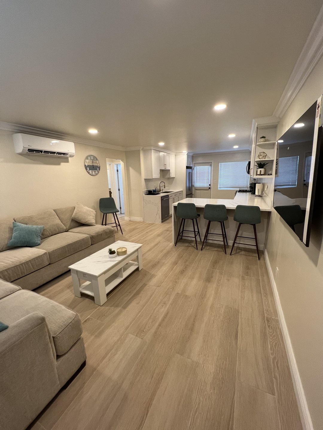 Furnished common living area with sofa and dining seating at Her Aria women's recovery housing in Montclair