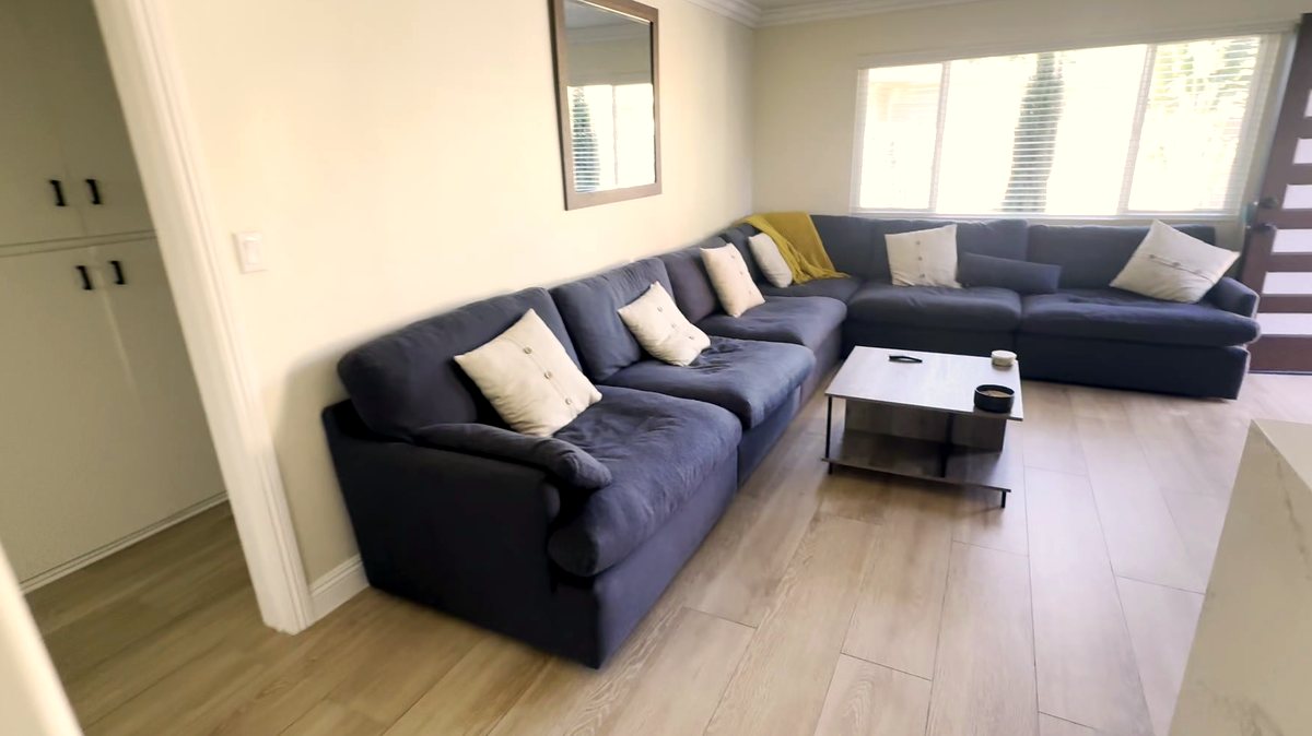 Living room in a women's sober living home in Montclair, CA — sectional sofa, open floor plan