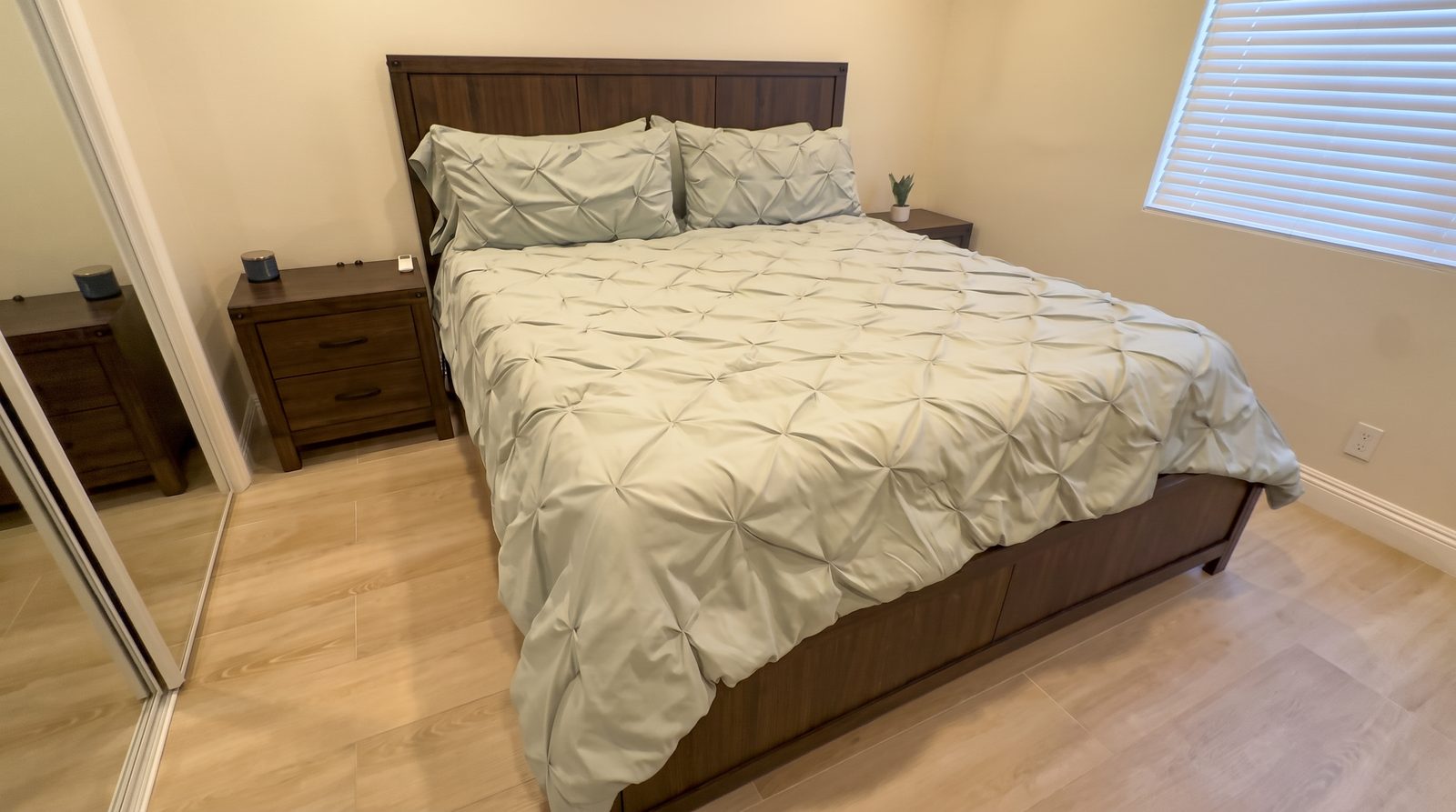 Furnished bedroom with full bed, nightstand and closet at Her Aria women's recovery residence serving Los Angeles and San Bernardino Counties